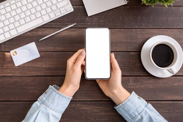 istock Woman hands holding smartphone with blank white screen in office 1178926272