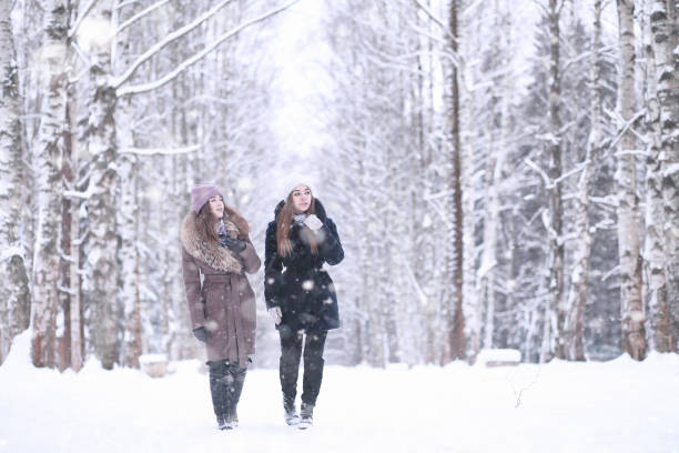 istock Girl in a winter park in snowfall 1178926475