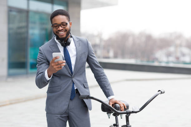 istock Happy entrepreneur texting on phone near bicycle 1178926510