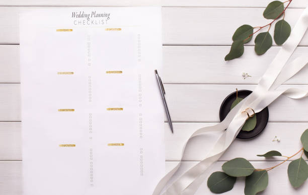 istock Wedding planning checklist with items on white wood 1178926532