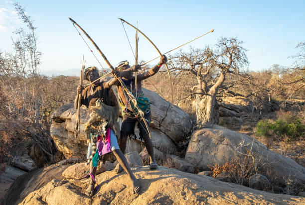 hadzabe men with bows and arrows stock photo