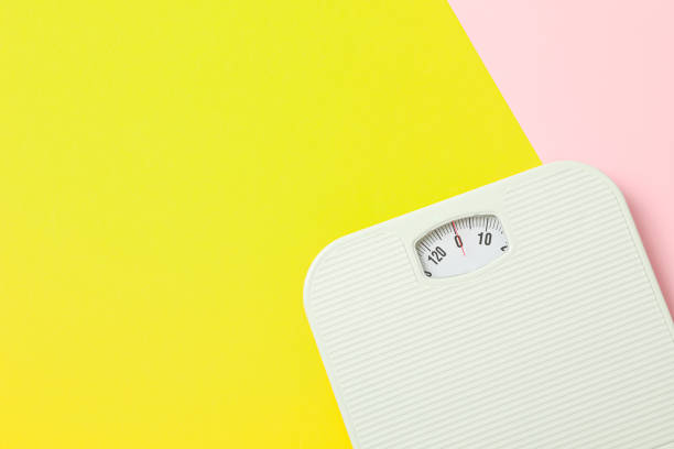 istock White weigh scales on two tone background, space for text 1178927966