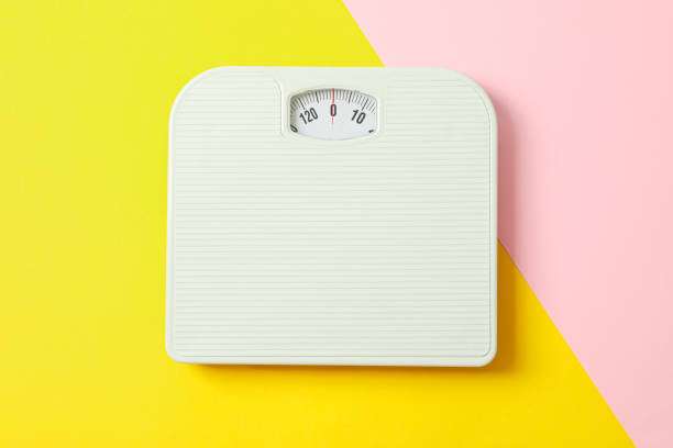 istock White weigh scales on two tone background, space for text 1178928299