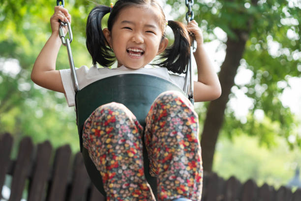 istock Cute girl swinging 1178929074