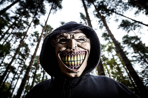 istock Scary Halloween Mask Guy in the Forest 1178929908