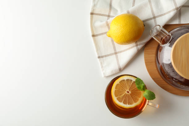 istock Cup of tea, mint, lemon, tea pot and towel on white background, copy space 1178930748