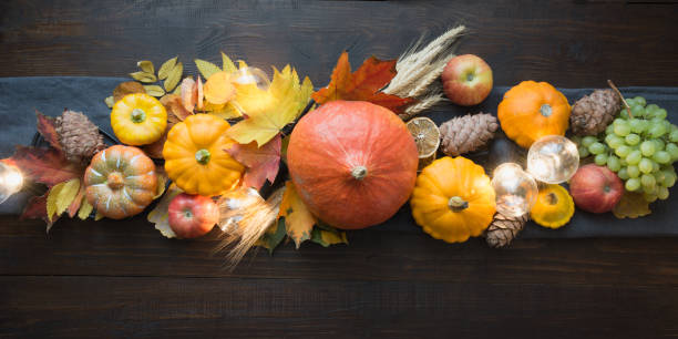 istock Fall decor for Thanksgiving Day with pumpkins, leaves, apples, lights on wooden table. 1178931049