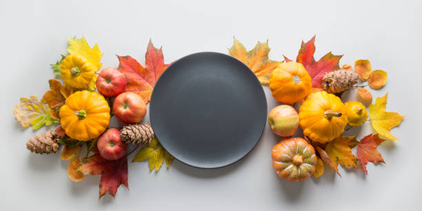 istock Fall decor for Thanksgiving Day with pumpkins, leaves, apples on grey. 1178931056