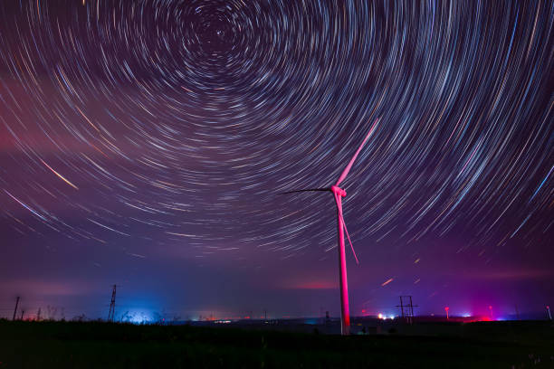 istock Wind turbines and star trails at night 1178931188