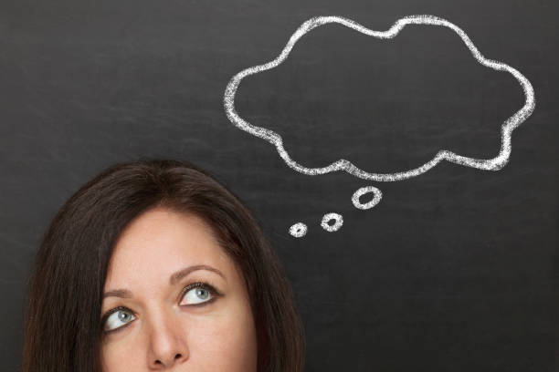 istock Woman thinking in front of blackboard 1178931277
