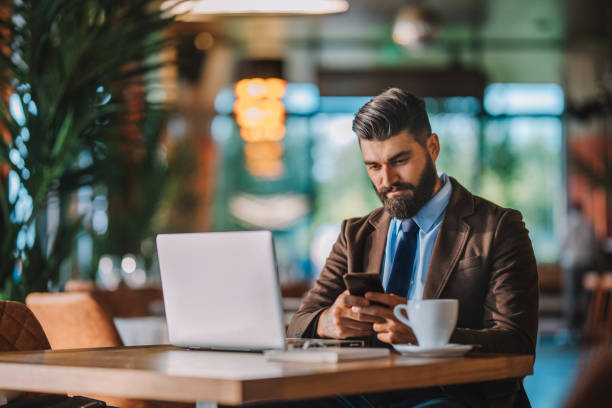 istock Business man drinking coffee and working in cafe 1178934834