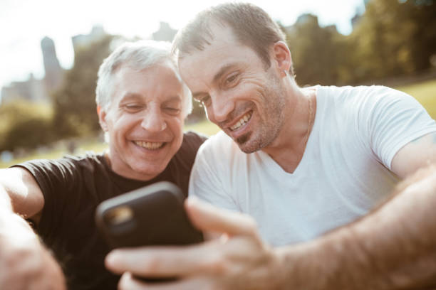 istock gay couple flirting on central park 1178935061