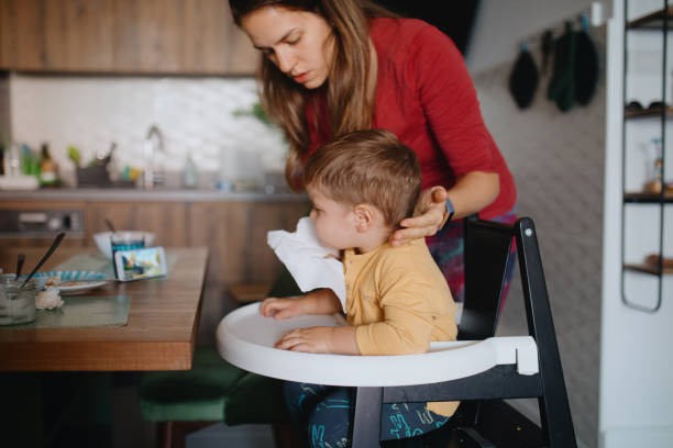 istock Mother cleaning son's face after breakfast 1178935163