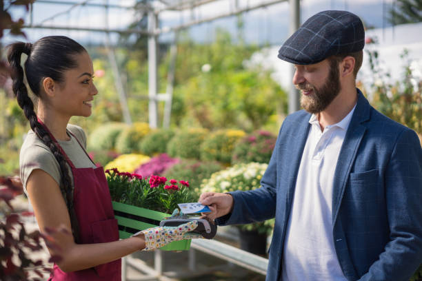 istock Man making mobile payment at the greenhouse 1178940676