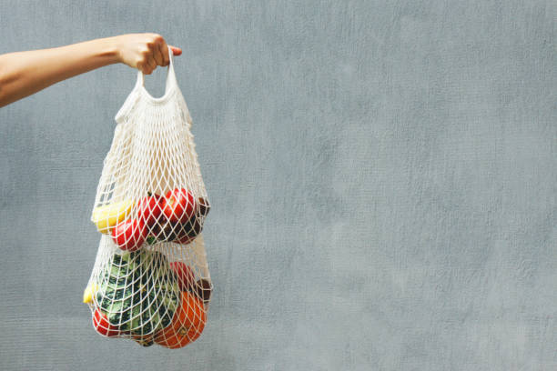 istock Hand with an eco bag on a gray background. 1178941855