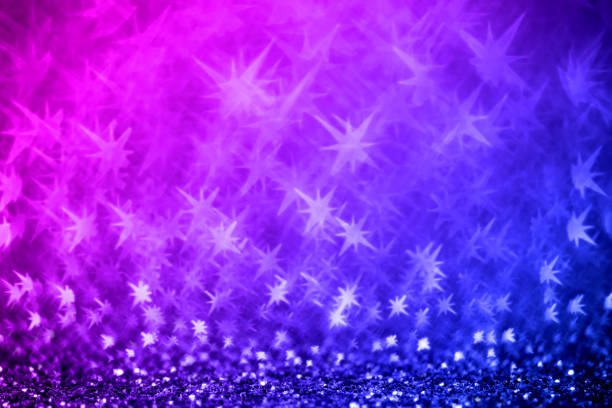 Christmas background - defocused bokeh with star shape in blue / purple tones. Space for copy. It's a real bokeh photo, not an illustration or computer effect.