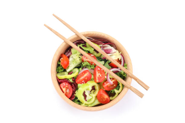 istock Fresh salad and chopsticks isolated on white background 1178943490