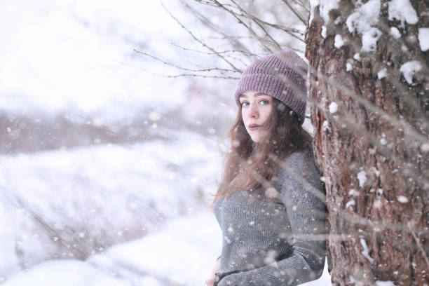 istock Girl in a winter park in snowfall 1178943650