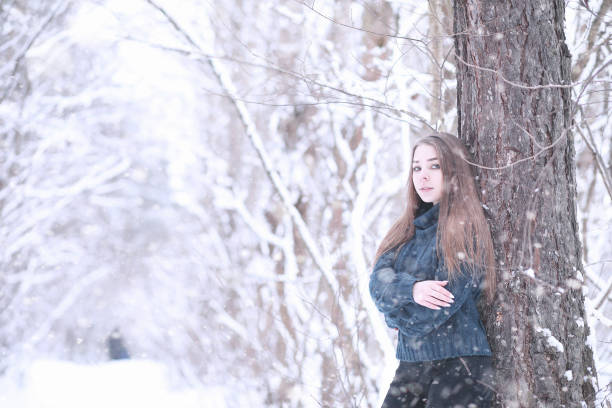 istock Girl in a winter park in snowfall 1178943675