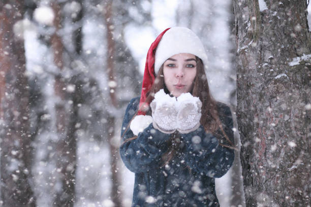istock Girl in a winter park in snowfall 1178943769
