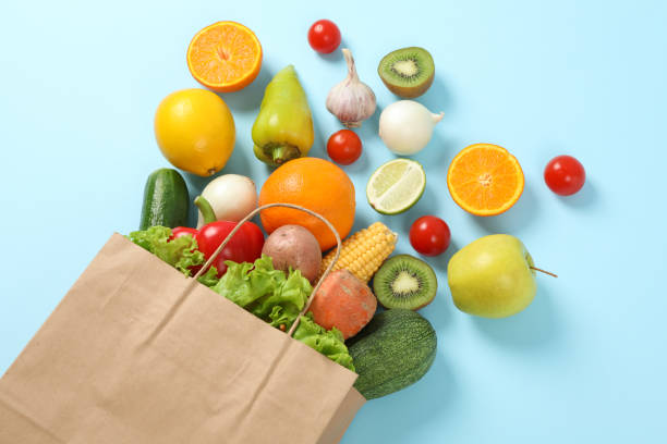 istock Paper bag, vegetables and fruits on blue background, space for text 1178944727