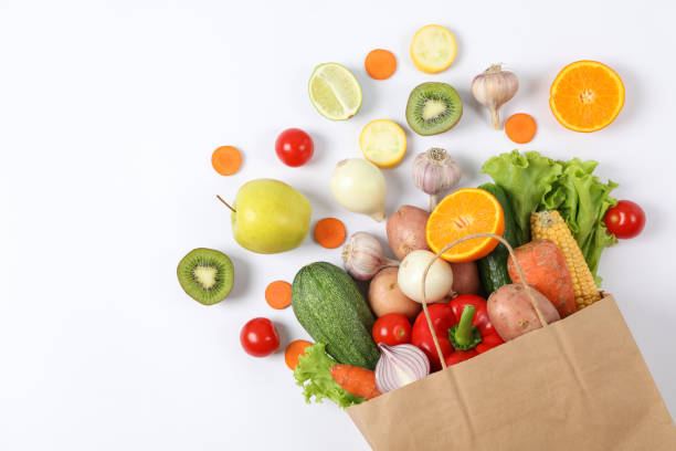 istock Flat lay with paper bag, vegetables and fruits on white background, copy space 1178944923