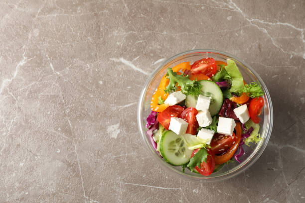 istock Glass bowl with fresh salad on grey background, copy space 1178945625