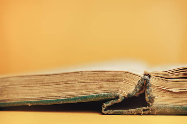 istock Close up Beautiful open old book on a yellow background. 1178946083