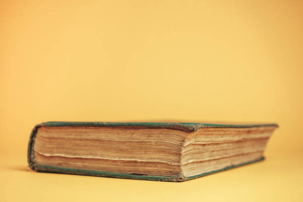 istock Close up Beautiful old book on a yellow background. 1178946280