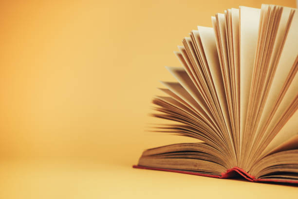 istock Beautiful open red book on a yellow background. 1178947580