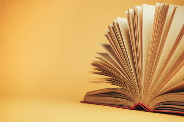 istock Beautiful open red book on a yellow background. 1178948161