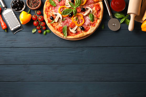 istock Delicious pizza and ingredients on wooden background, copy space 1178949068