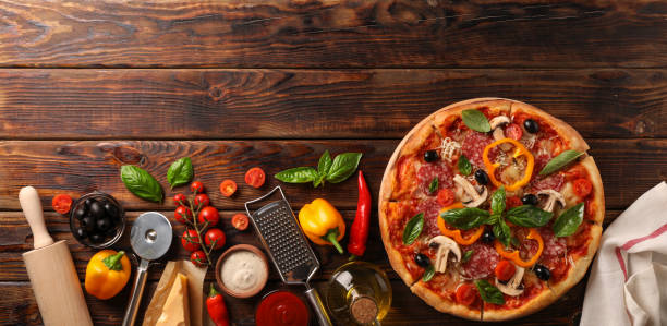 istock Delicious pizza and ingredients on wooden background, copy space 1178949098