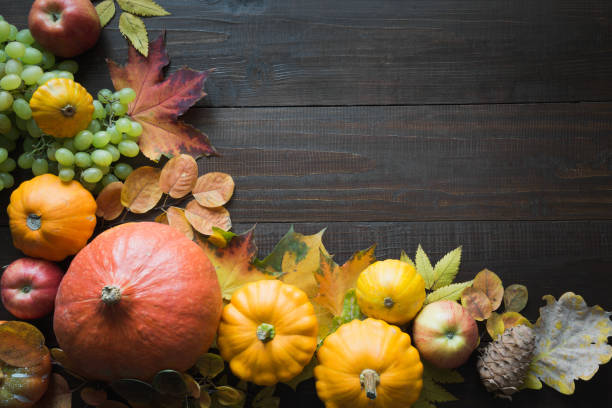 istock Frame of pumpkin and maple leaves on wooden board with space for text. Fall pattern. Top view. 1178949108