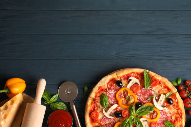 istock Delicious pizza and ingredients on wooden background, copy space 1178949667