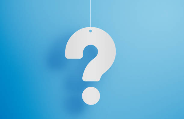 Hanging question mark on blue background stock photo stock photo