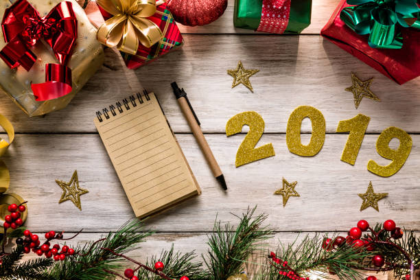 istock Christmas lights and decoration with presents making a frame with copy space. Christmas themes with new year 2019 sign. 1178950271