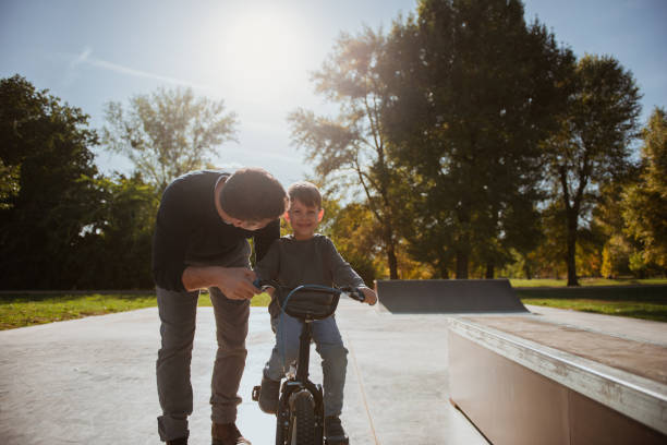istock Father Learning his son to ride a bicycle 1178951203