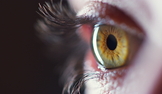 Cropped shot of an unrecognizable young woman's eye against a dark background