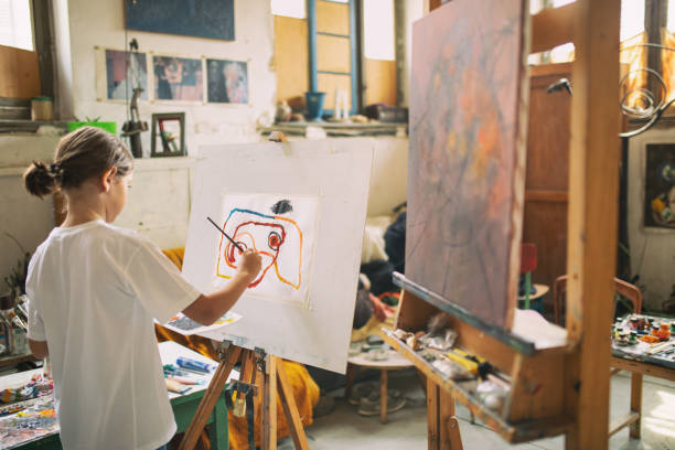 istock Boy working and painting in art studio 1178952411