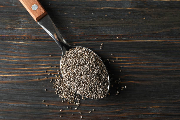 istock Spoon with chia on wooden background, copy space 1178952617