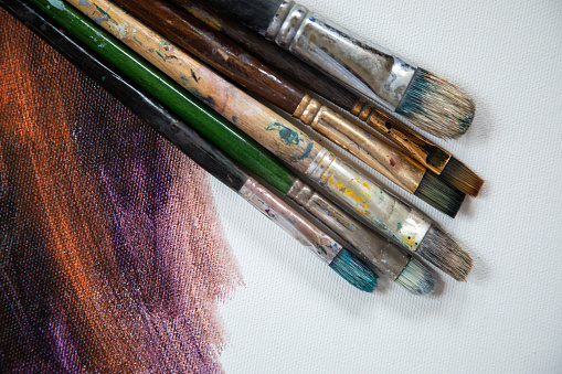 The palette of an artist with colorful mixed paints