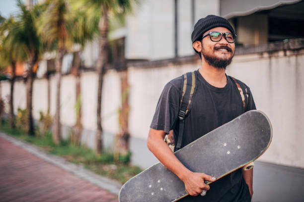 istock Young man with skateboard on the street 1178956000