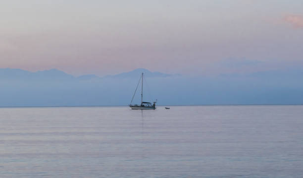 istock Lonely ship in the sea at sunset 1178957222