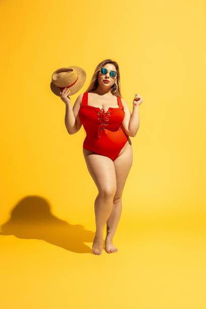Young caucasian plus size female model's preparing for beach resort