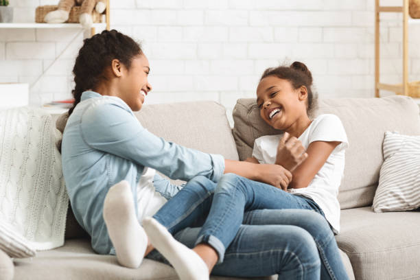 istock Cute black sisters having fun together at home 1178960037