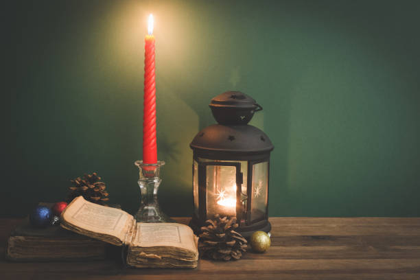 istock Vintage lantern and candle on old books. Candle burning 1178960473