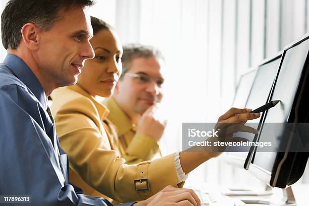 Business People Looking At Computer Monitor Stock Photo - Download Image Now - Adult, Adults Only, Desktop PC