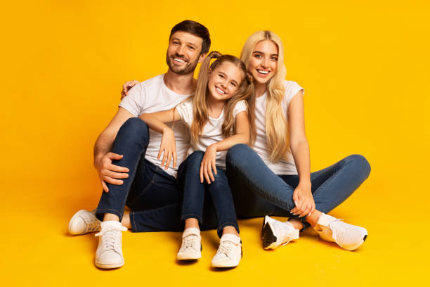 istock Parents And Little Daughter Sitting And Hugging On Floor, Studio 1178963142