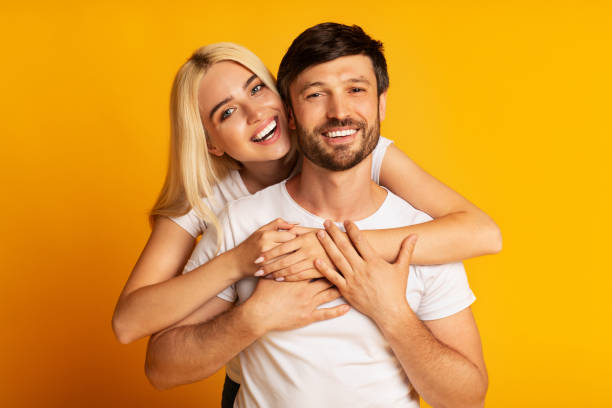 istock Happy Couple Hugging Standing Over Yellow Background, Studio Shot 1178963204